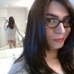 Crossdresser Liz Summers wearing an open-knit sweater and panties