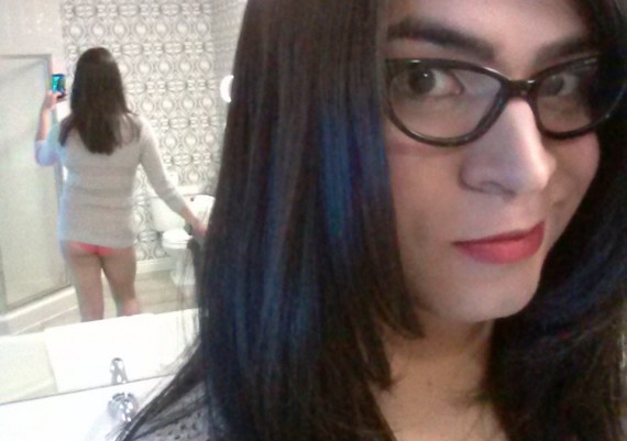 Crossdresser Liz Summers wearing an open-knit sweater and panties